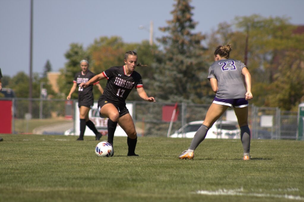 Senior Lindsay Cole holds strong as her Eagle opponent challenges her at the South Athletic Complex.
