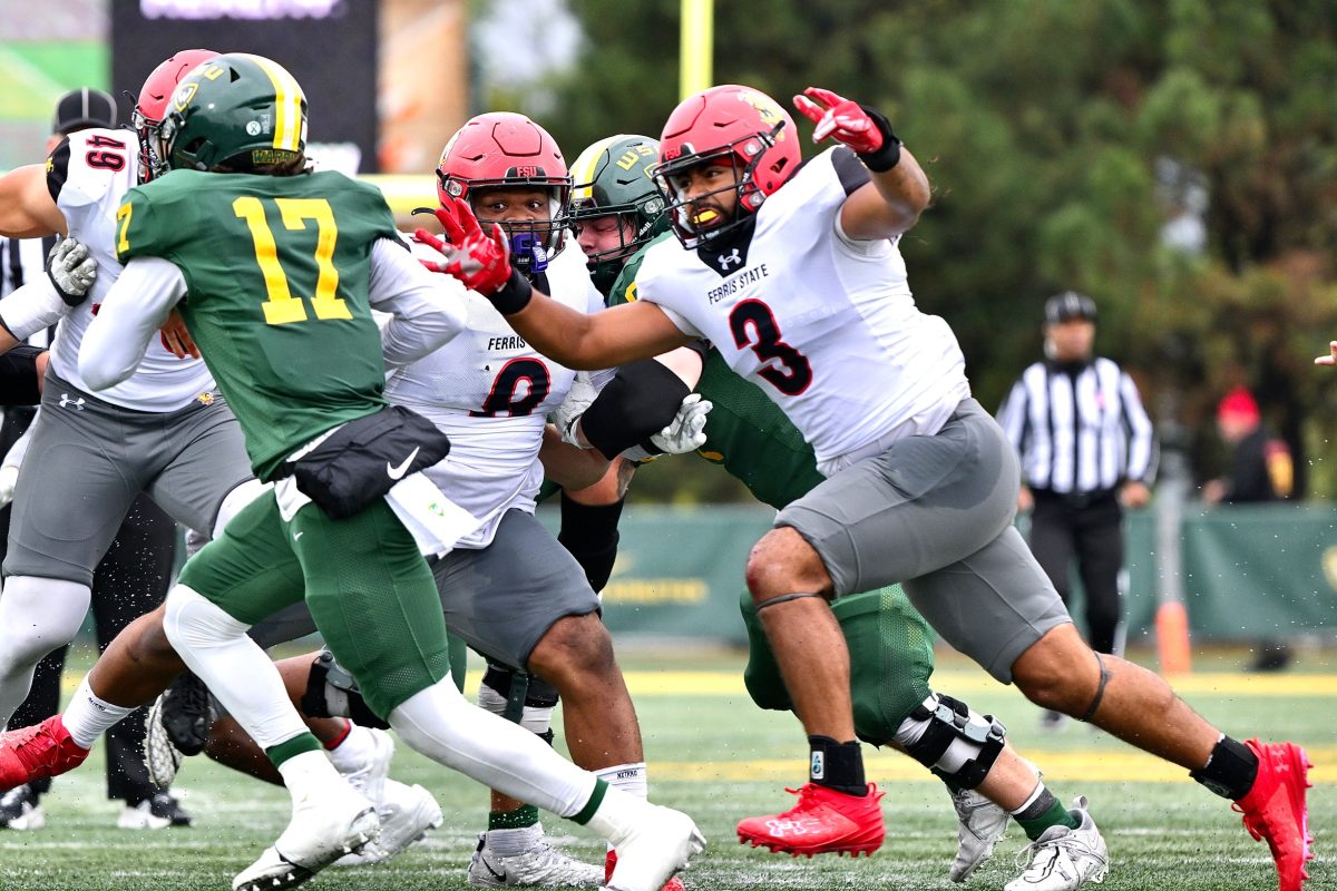 Saipaia goes for a sack on Wayne State quarterback Champion Edwards.