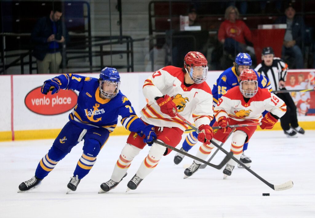 Gavin Best fights off a defender against Lake Superior State.